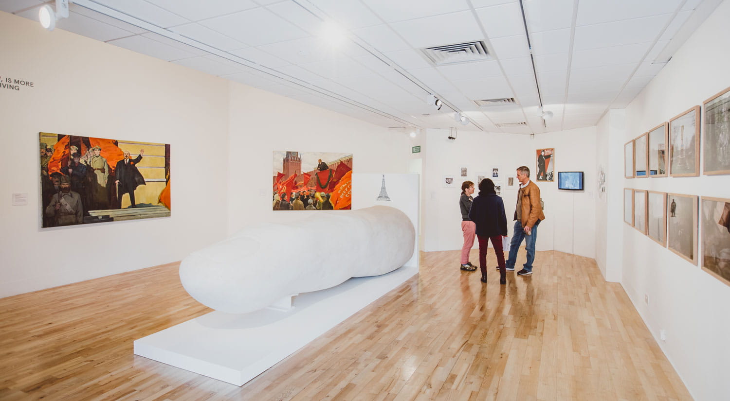 Inside Art Exchange gallery during an exhibition with a couple of visitors