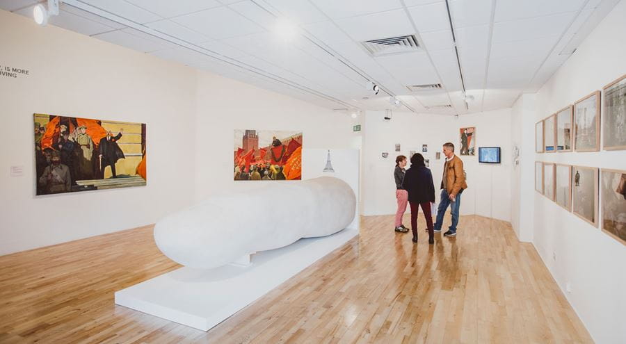 Inside Art Exchange gallery during an exhibition with a couple of visitors