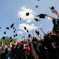Graduates throwing their graduation caps- ready to join the working world