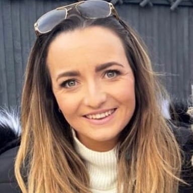 Physiotherapy graduate Alice George with a pair of glasses on the top of her head.