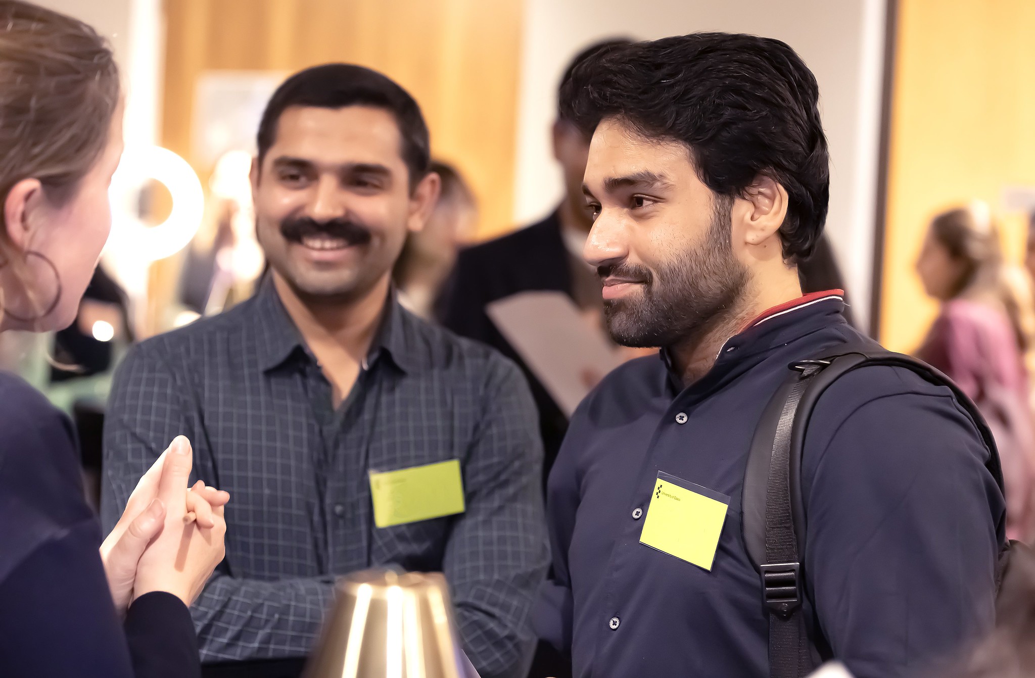 Two male students chatting to someone