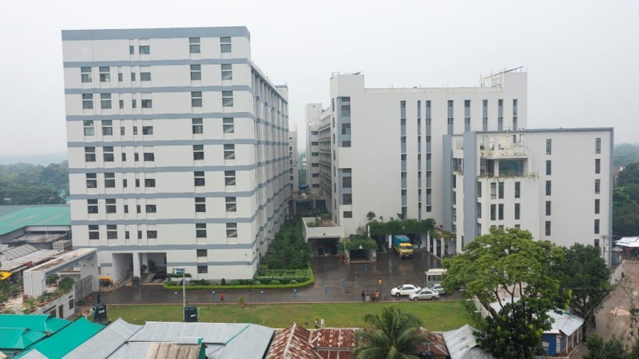 The DBG Group factory in Bangladesh, three large white and grey buildings.