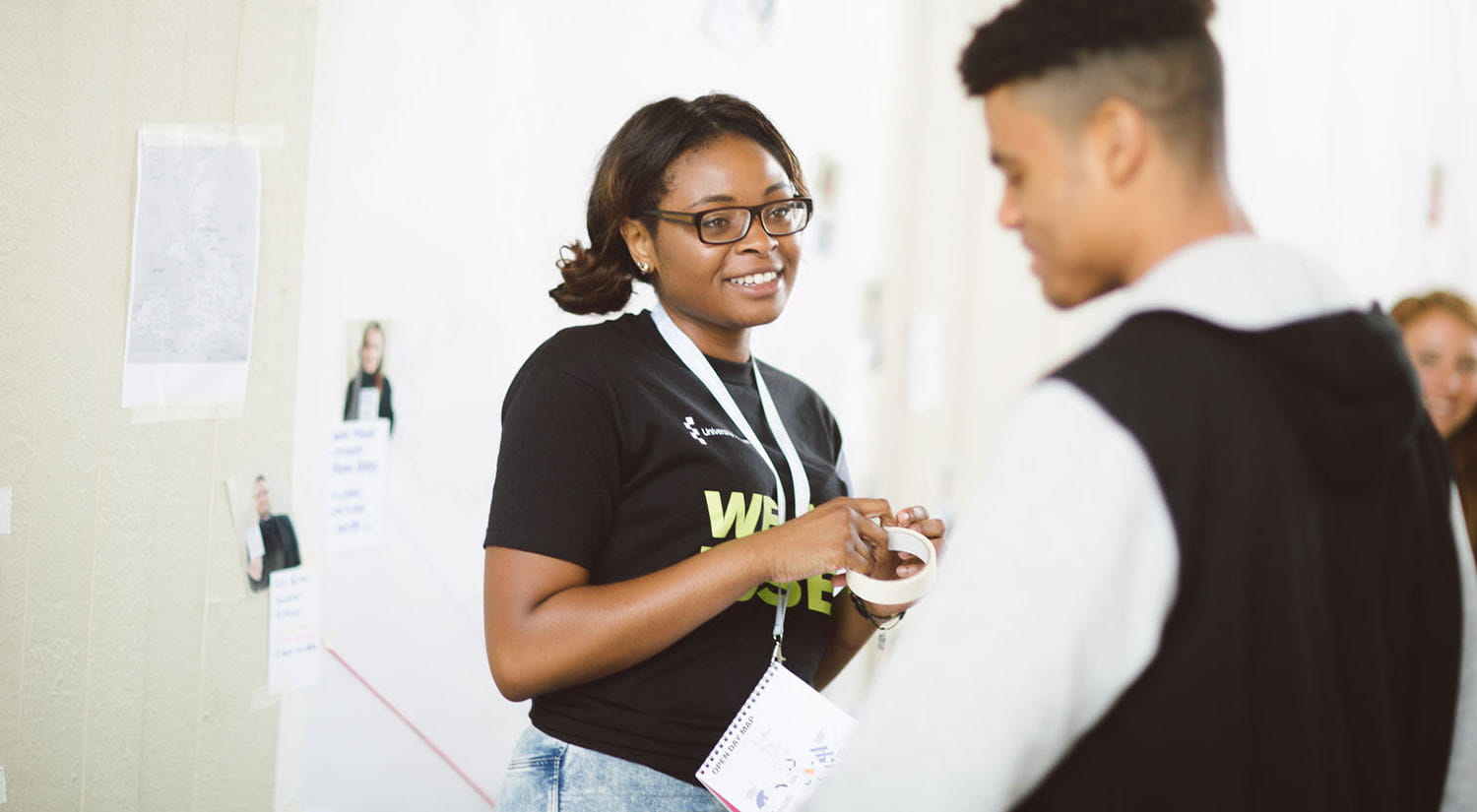 A current student helping out at an open day and talking to a prospective student