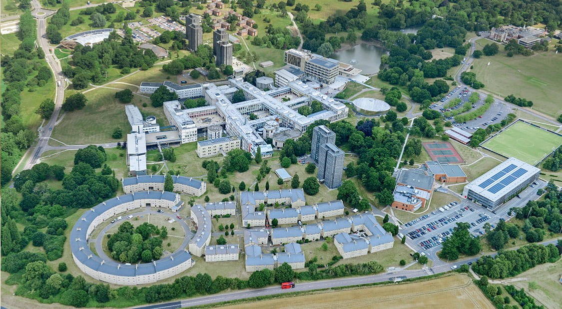 An aerial show of Colchester campus from the north of campus. Student accommodation, sports facilities and the iconic lake can be seen.