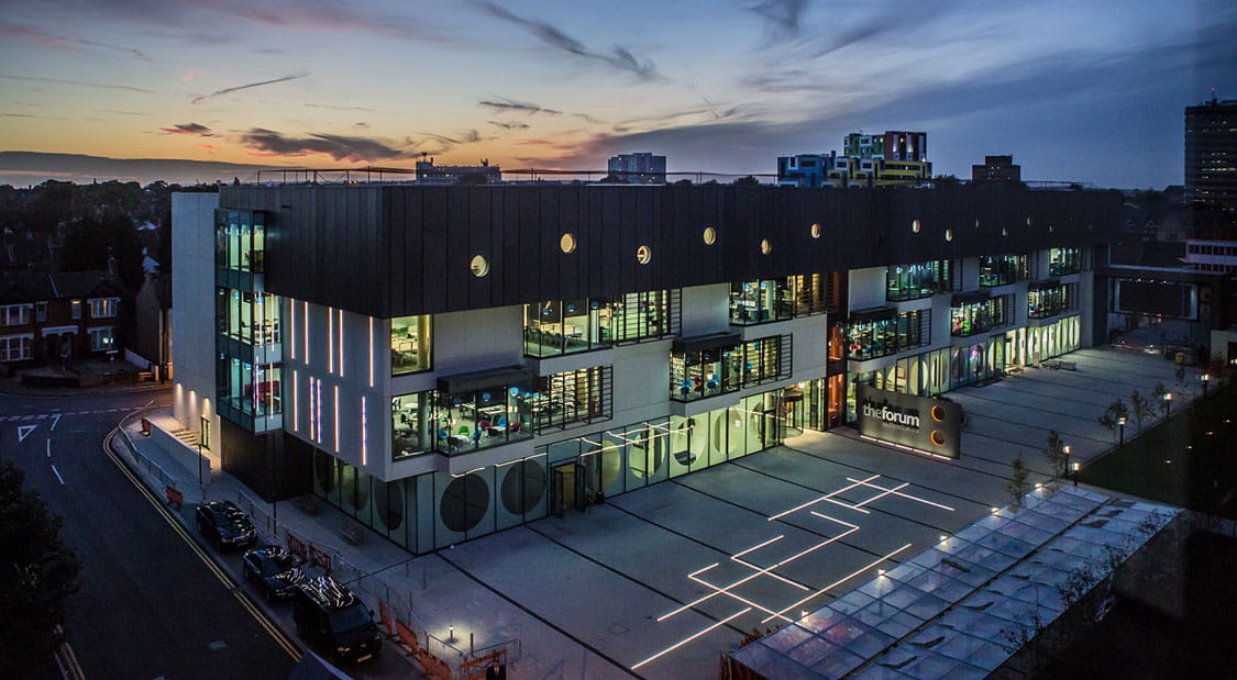 Image of the Forum Building on the Southend Campus taken at night.