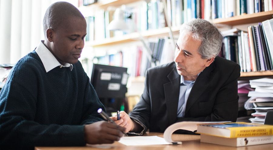 Image of a student working with a member of staff